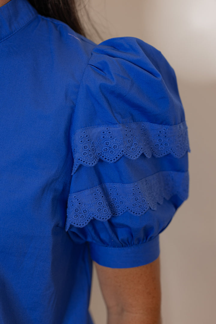 Women’s royal blue short sleeve dressy top, showing closeup of sleeve. 
