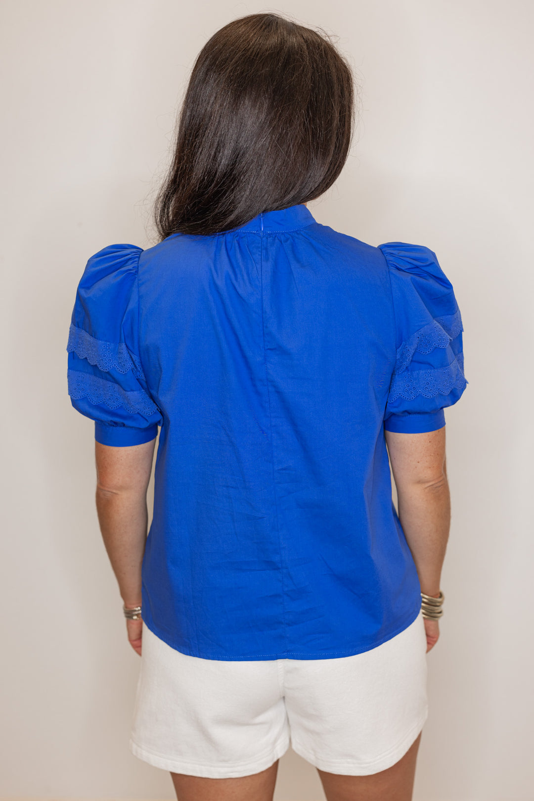 Women’s royal blue short sleeve dressy top, showing back view. perfect for summer events. 