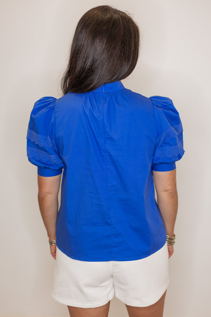 Women’s royal blue short sleeve dressy top, showing back view. perfect for summer events. 