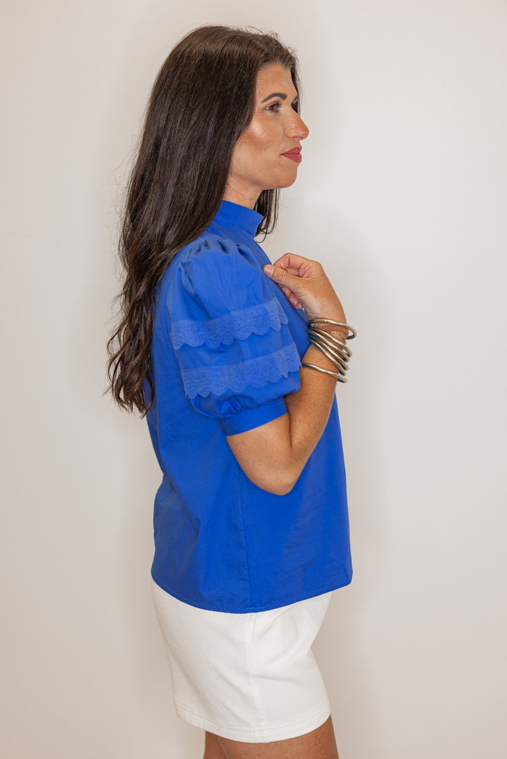 Women’s royal blue short sleeve dressy top, showing side view 