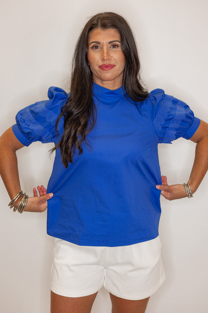 Women’s royal blue short sleeve dressy top showing fit of blouse. perfect for summer events. 