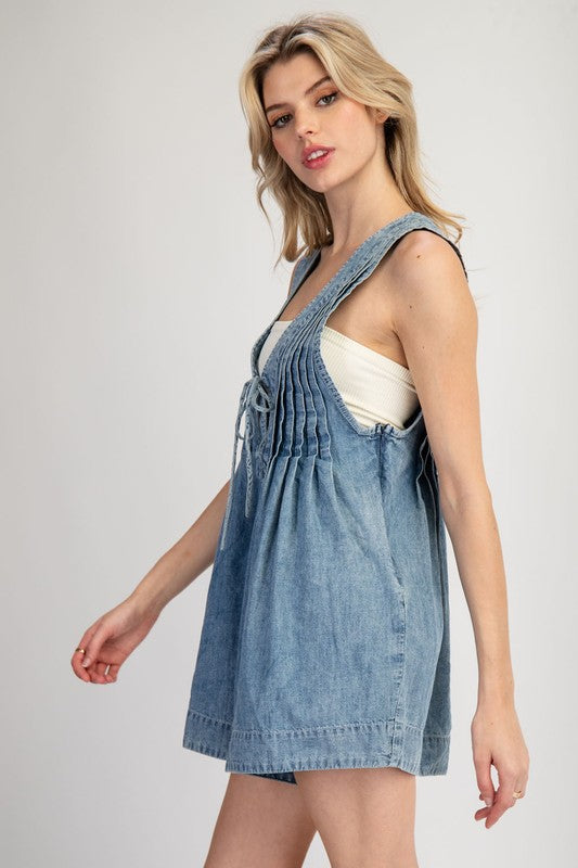 ee:some Washed blue denim sleeveless romper with a ruched bodice and bow tie v neck
