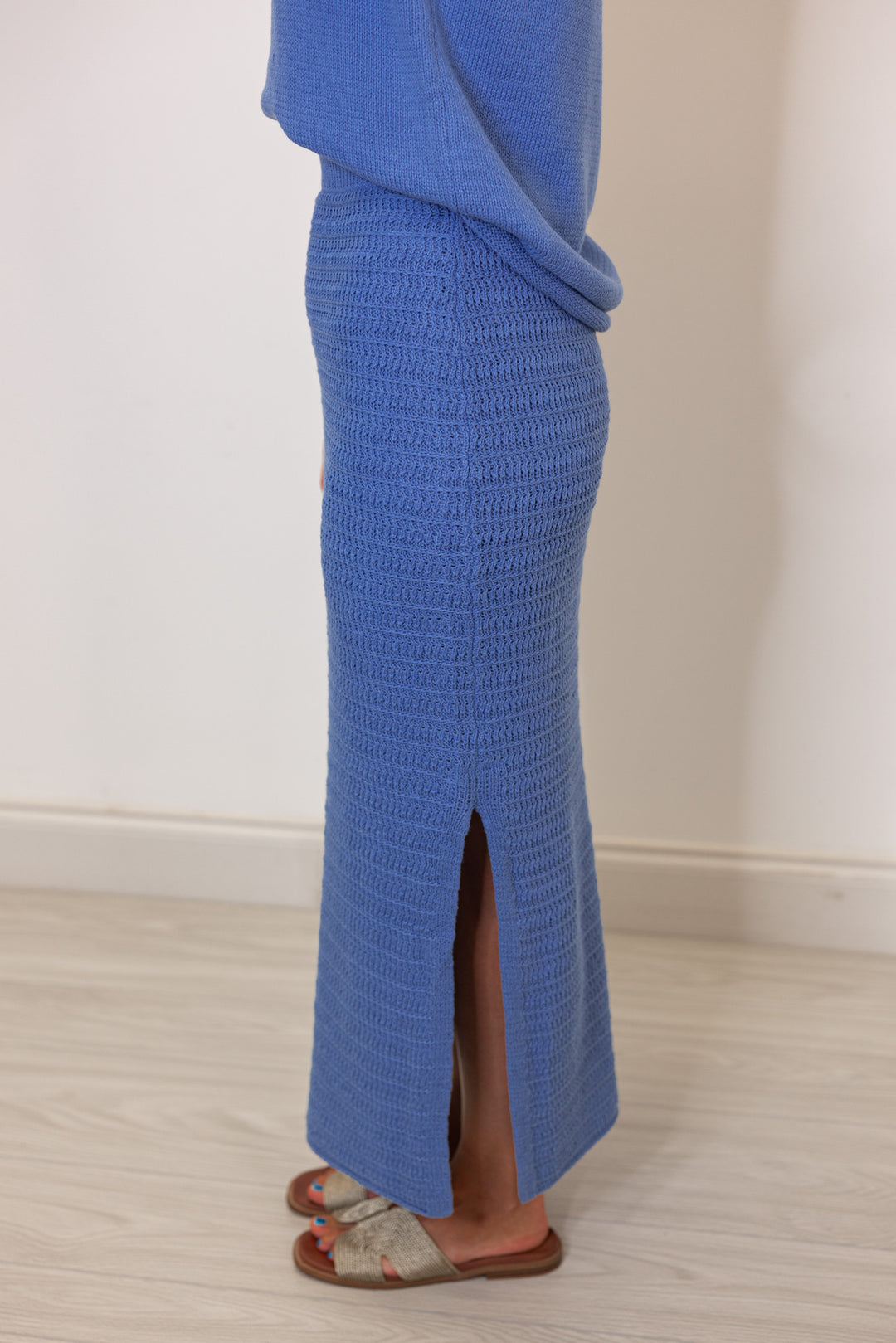 Women's blue sweater knit maxi skirt with matching sleeveless contrasting knit top by Wishlist showing up close side view of skirt