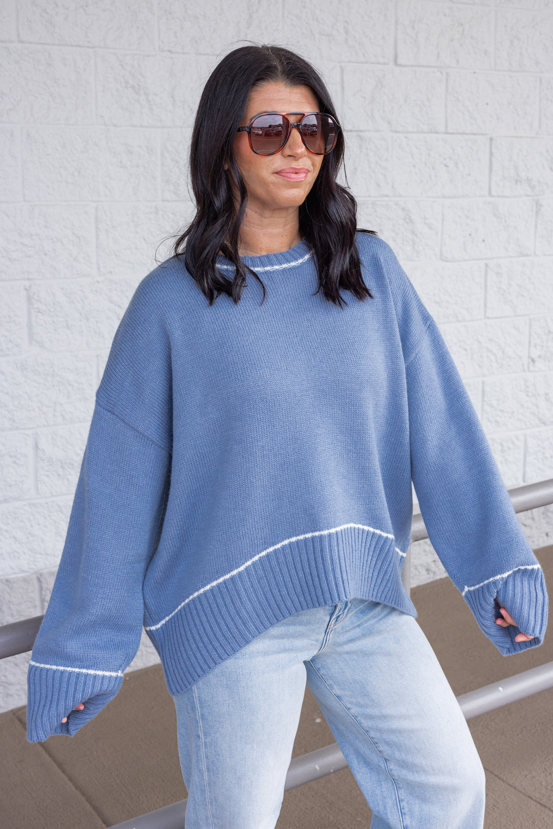 Women's blue knit sweater with cream trim details by Wishlist showing front, slight side view