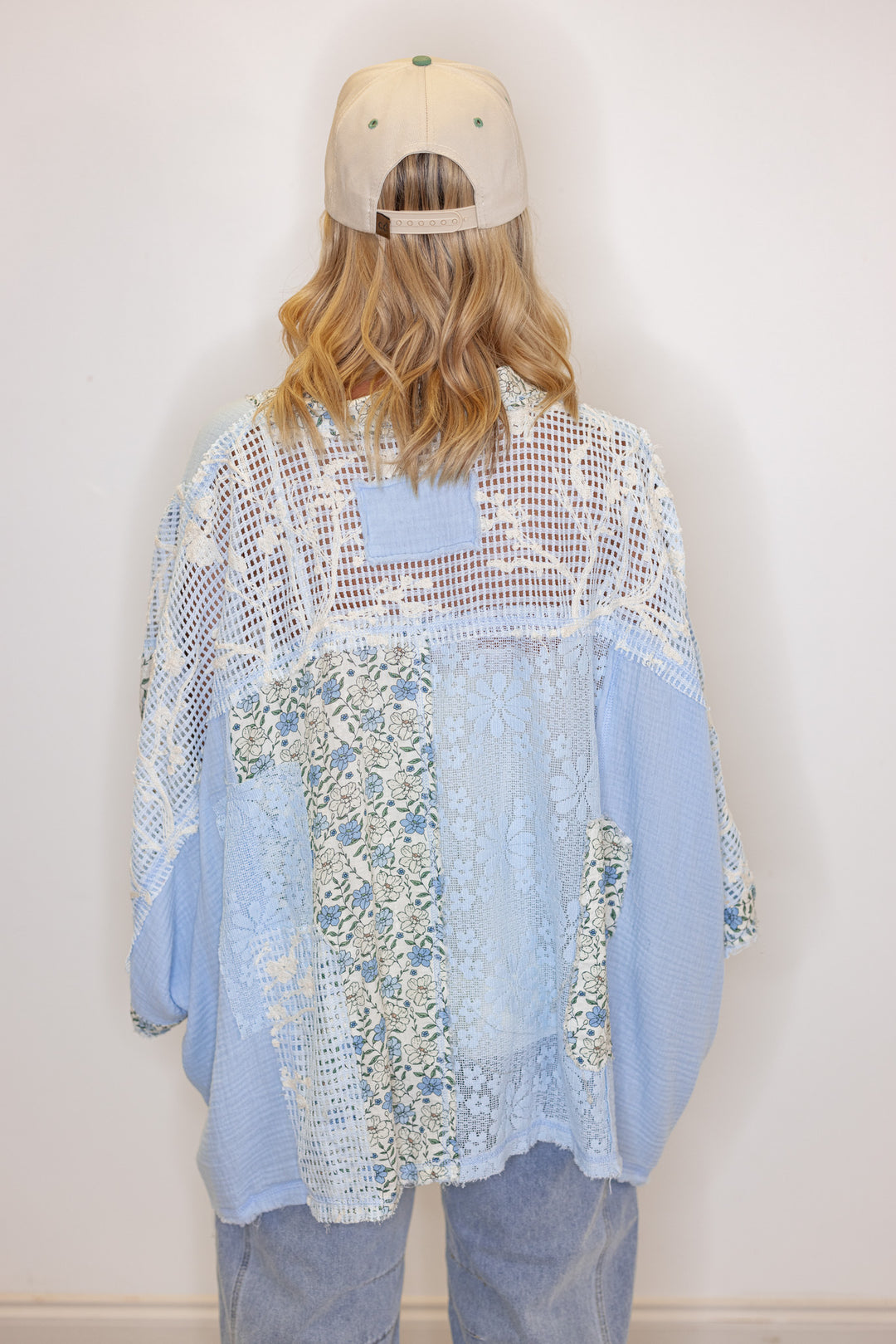 Women's sky blue gauze cardigan top with floral print and floral lace patchwork by POL showing back view