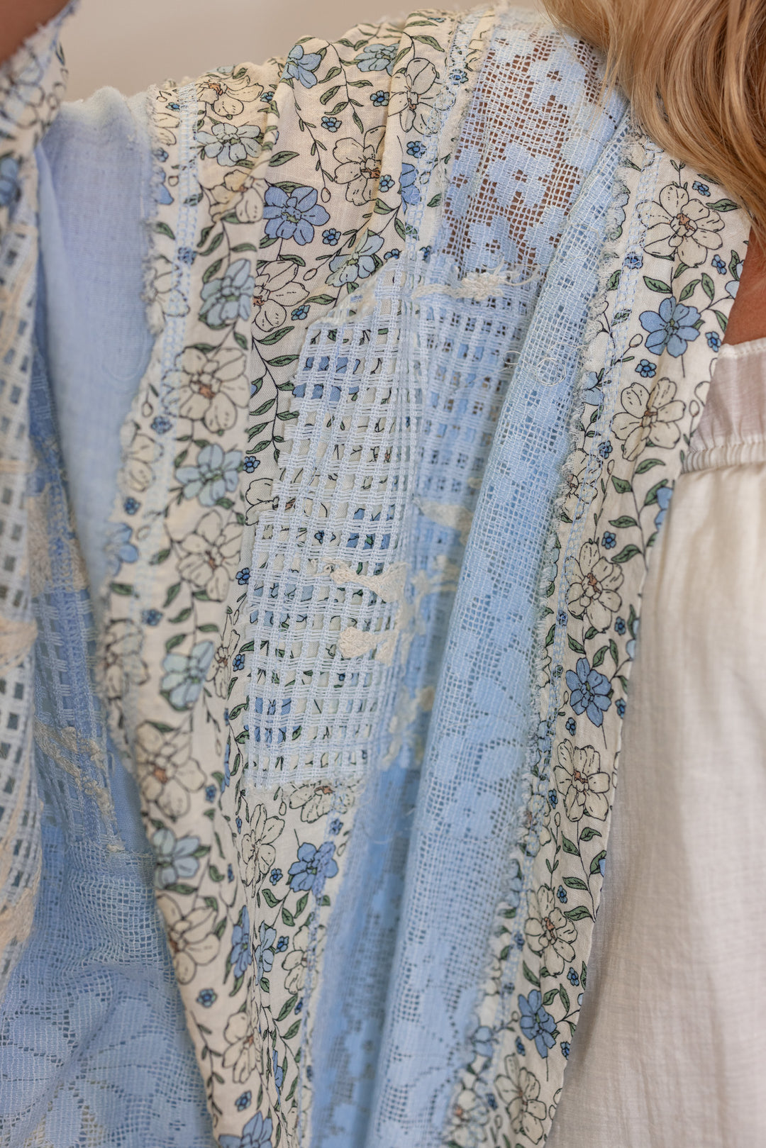 Women's sky blue gauze cardigan top with floral print and floral lace patchwork by POL showing floral and lace detail