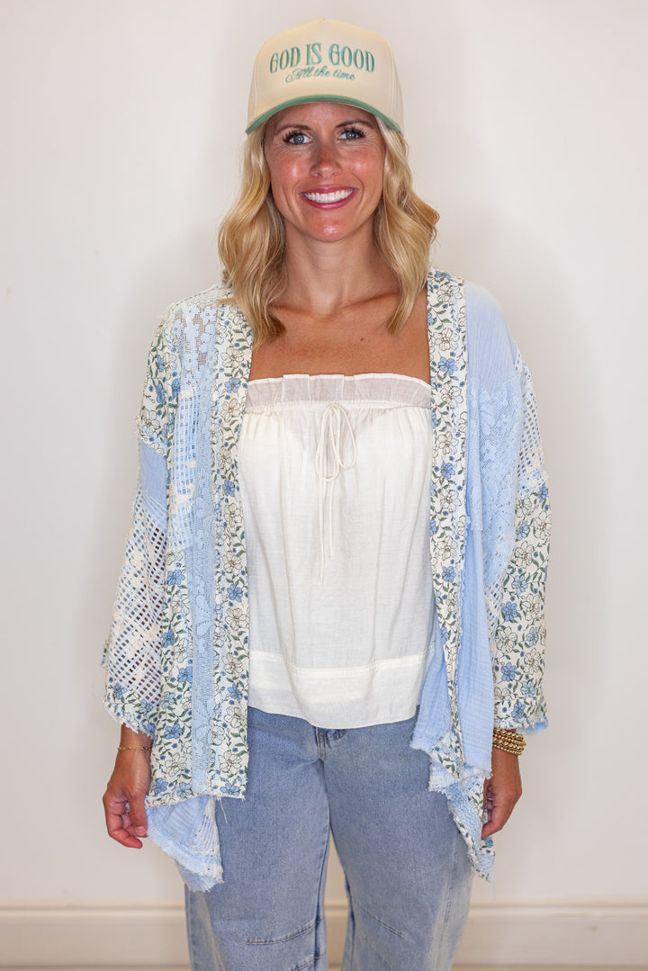 Women's sky blue gauze cardigan top with floral print and floral lace patchwork by POL showing up close front view