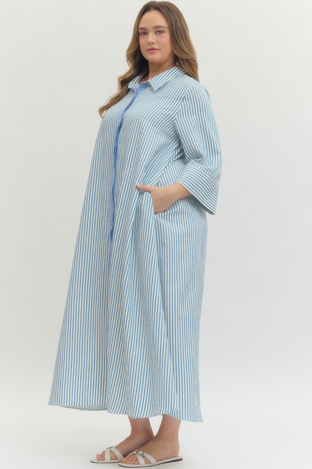 Women's plus size striped blue maxi dress by Entro showing side pockets