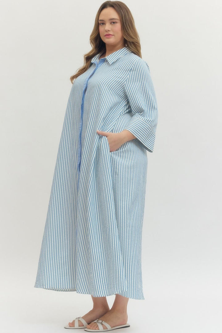 Women's plus size striped blue maxi dress by Entro showing side pockets