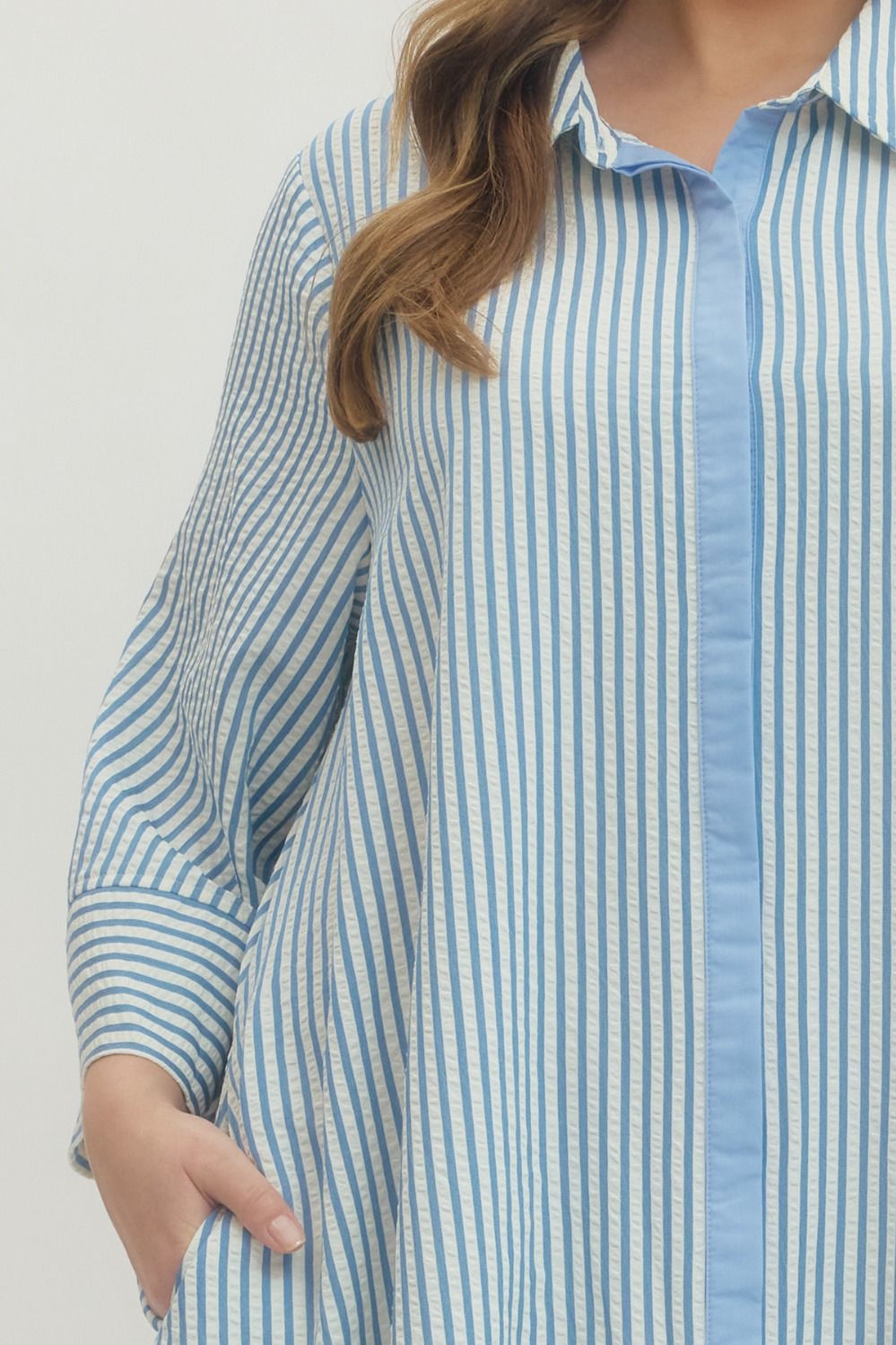 Women's plus size striped blue maxi dress by Entro showing hidden buttons and side pockets