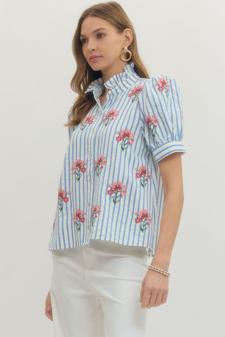 Entro blue and white striped button front top with pink and red embroidered flowers and a ruffled neck