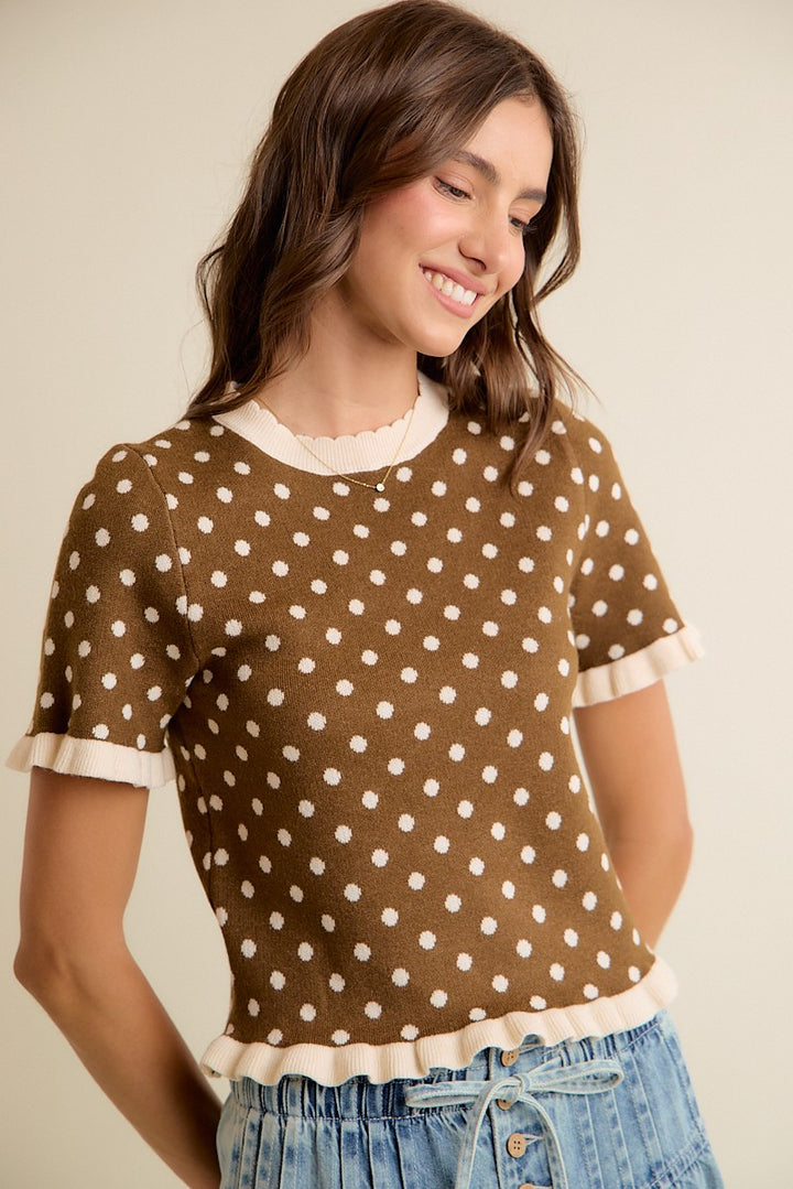 Brown and cream knit top with ruffle trim and a crew neckline