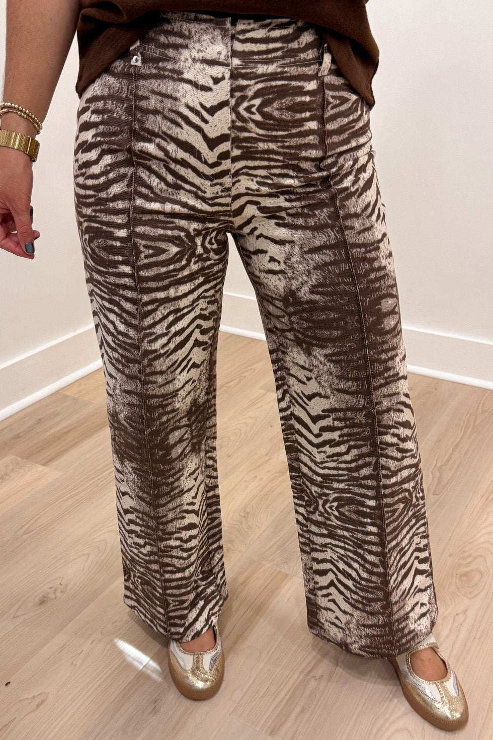 brown and cream zebra print wide leg twill denim pants with pintuck details and hook eye zipper closure