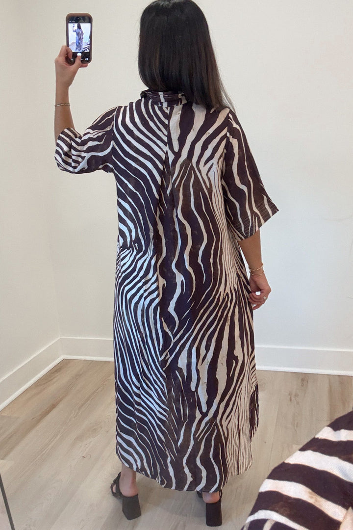 brown and ecru abstract zebra print half sleeve button front bodice midi dress with rounded bottom hem
