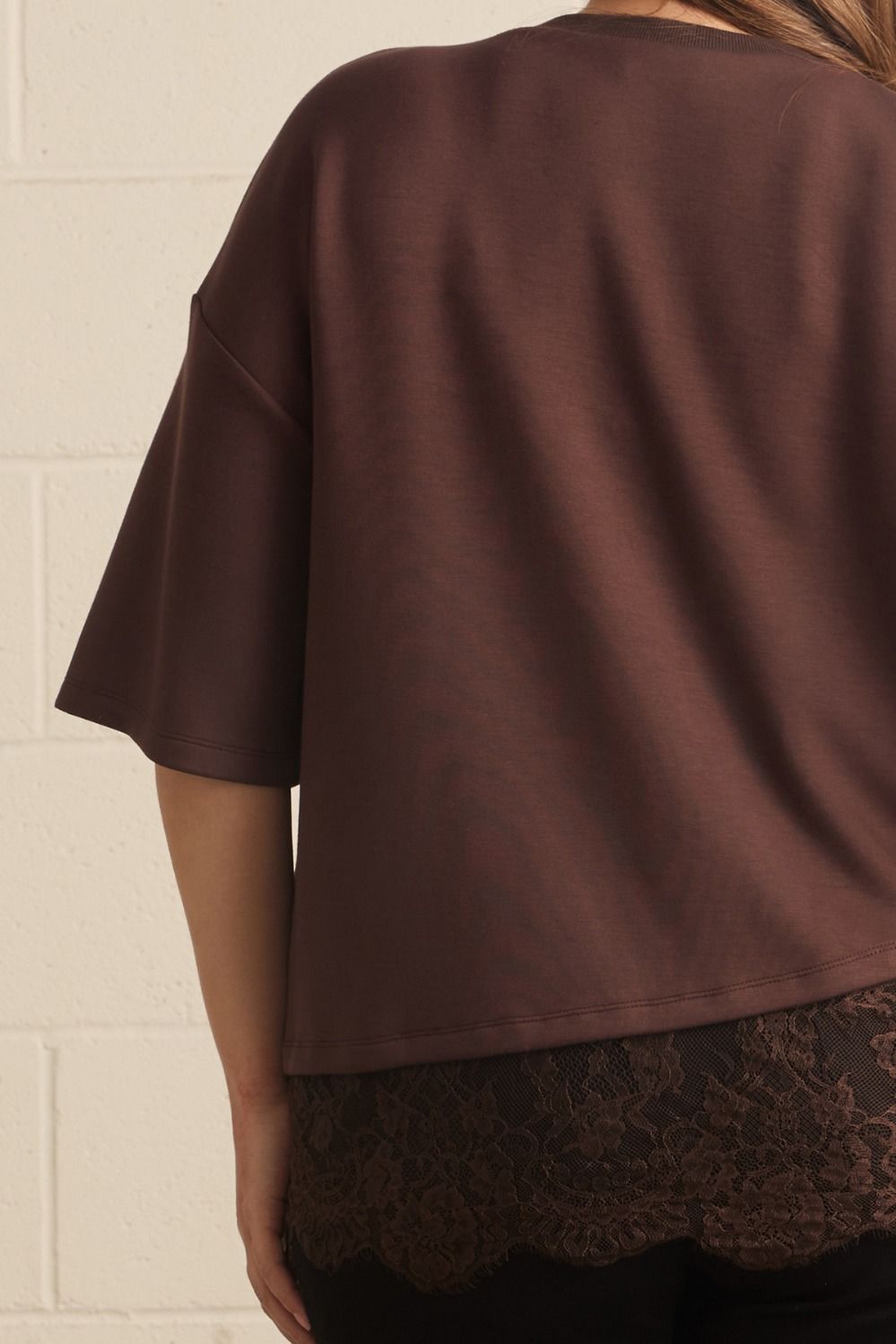 Entro plus size brown top with drop shoulder short sleeves and an asymmetrical tiered lace detail at hem 