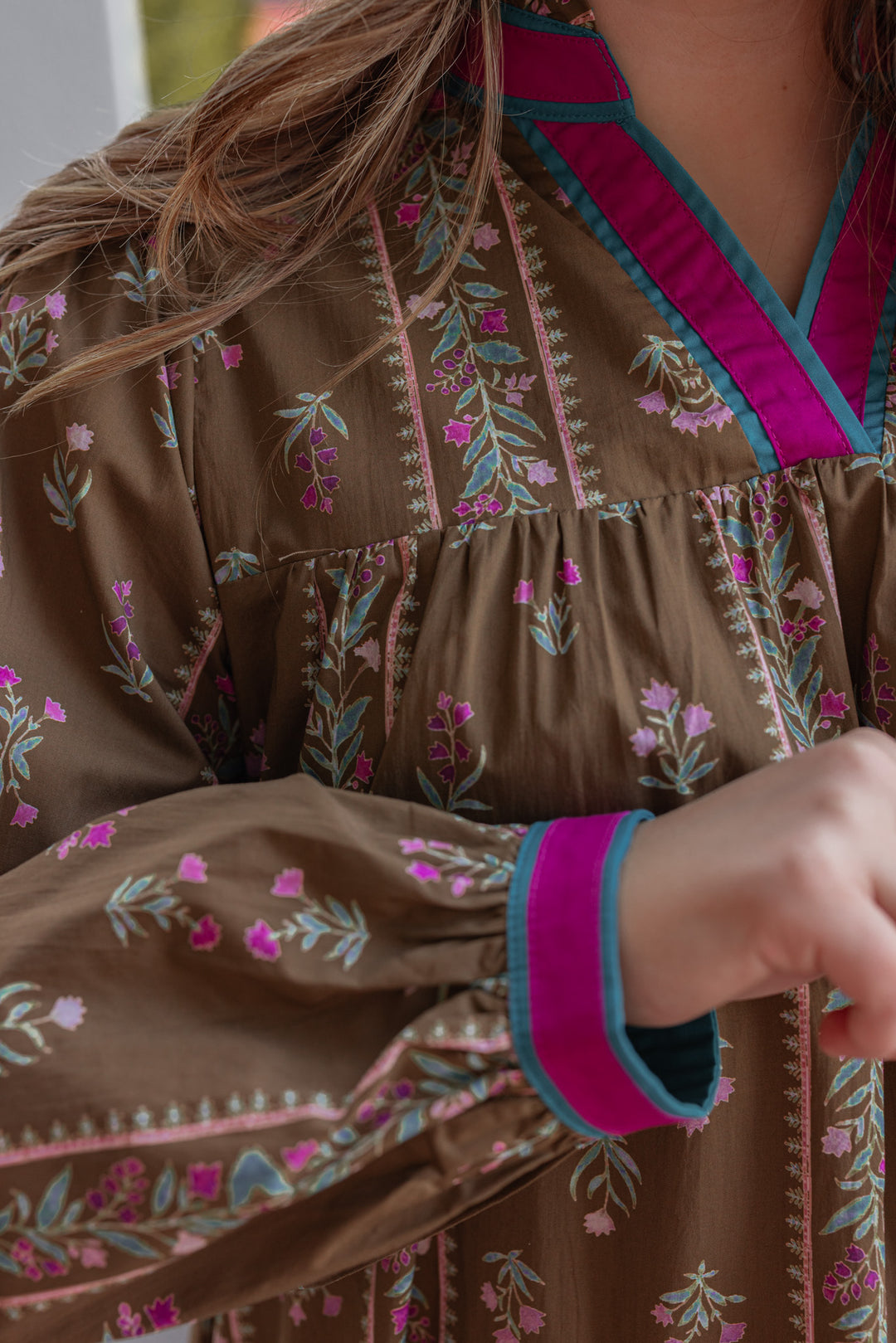 Women's brown olive babydoll dress by Jodifl showing floral trellis print and hot pink trim