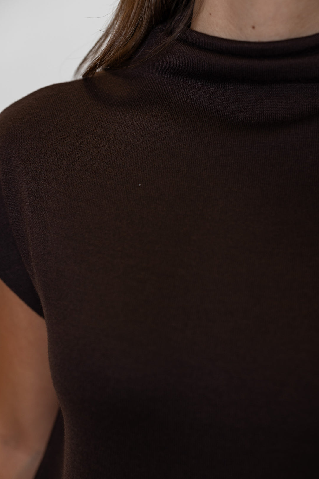 Women's brown knit cropped top by Entro, showing up close view of mock neckline