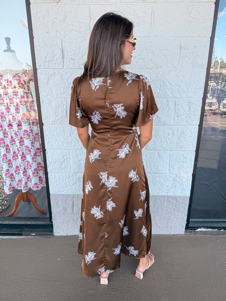 brown satin midi dress with light blue floral print and tie chest detail back view