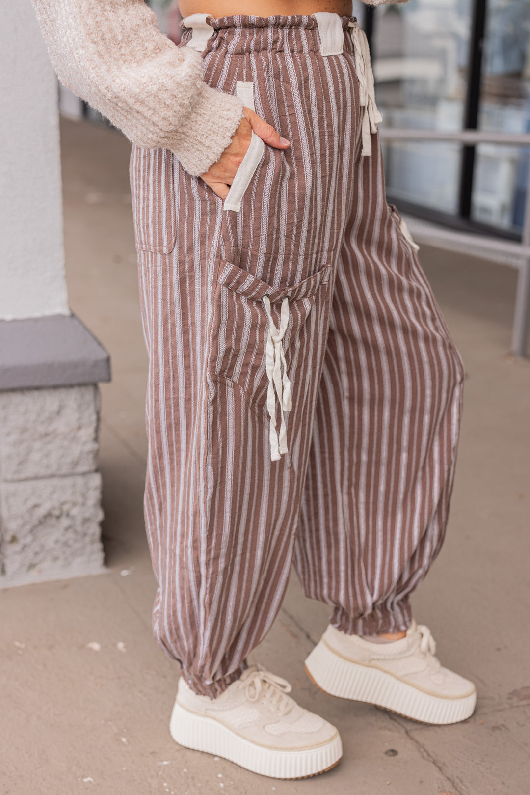 Women's milk chocolate brown linen cargo jogger pants with cream stripes by ee:some showing up close side view