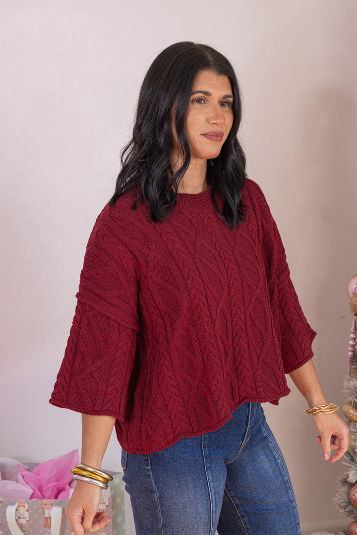 Women's burgundy cable knit cropped sweater by Entro showing up close front angled view