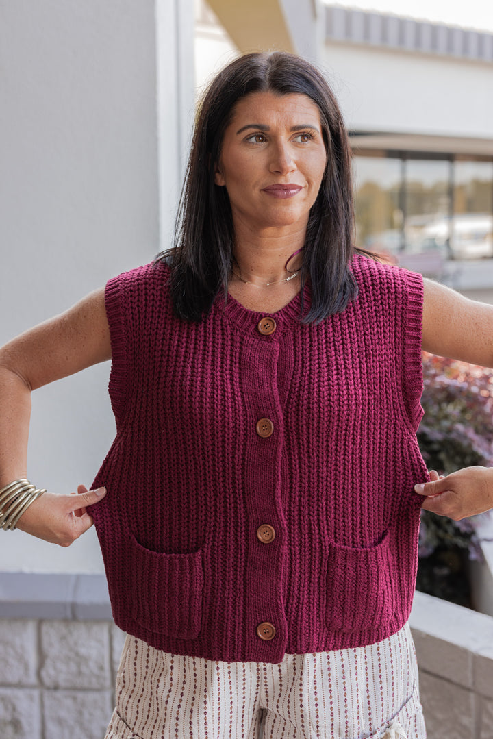 Women's burgundy wine knit button front sweater vest by Wishlist showing fabric contains stretch