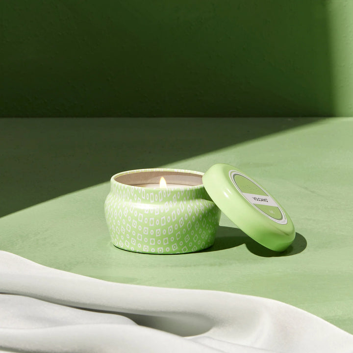 Capri Blue 3 oz Volcano iced matcha mini tin candle showing candle open and burning