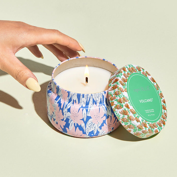 Capri Blue Volcano 8.5oz travel tin candle showing lid open and burning