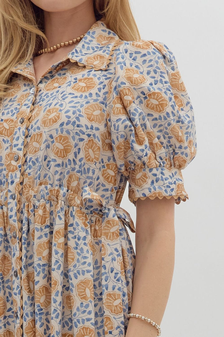 Women's cream button front midi dress with caramel and blue floral print by Entro showing side tie detailing