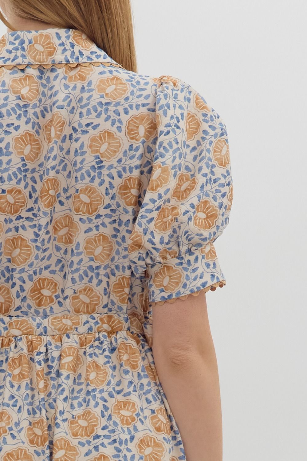 Women's cream button front midi dress with caramel and blue floral print by Entro showing up close back of sleeve