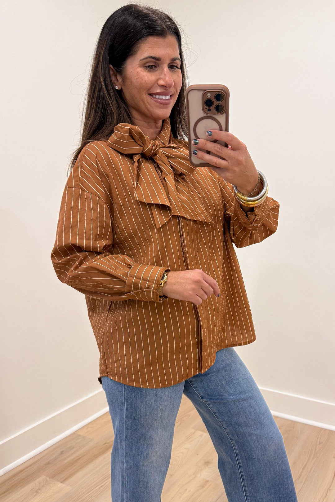 caramel and taupe striped mock neck long sleeve flap covered button front top with rounded bottom hem