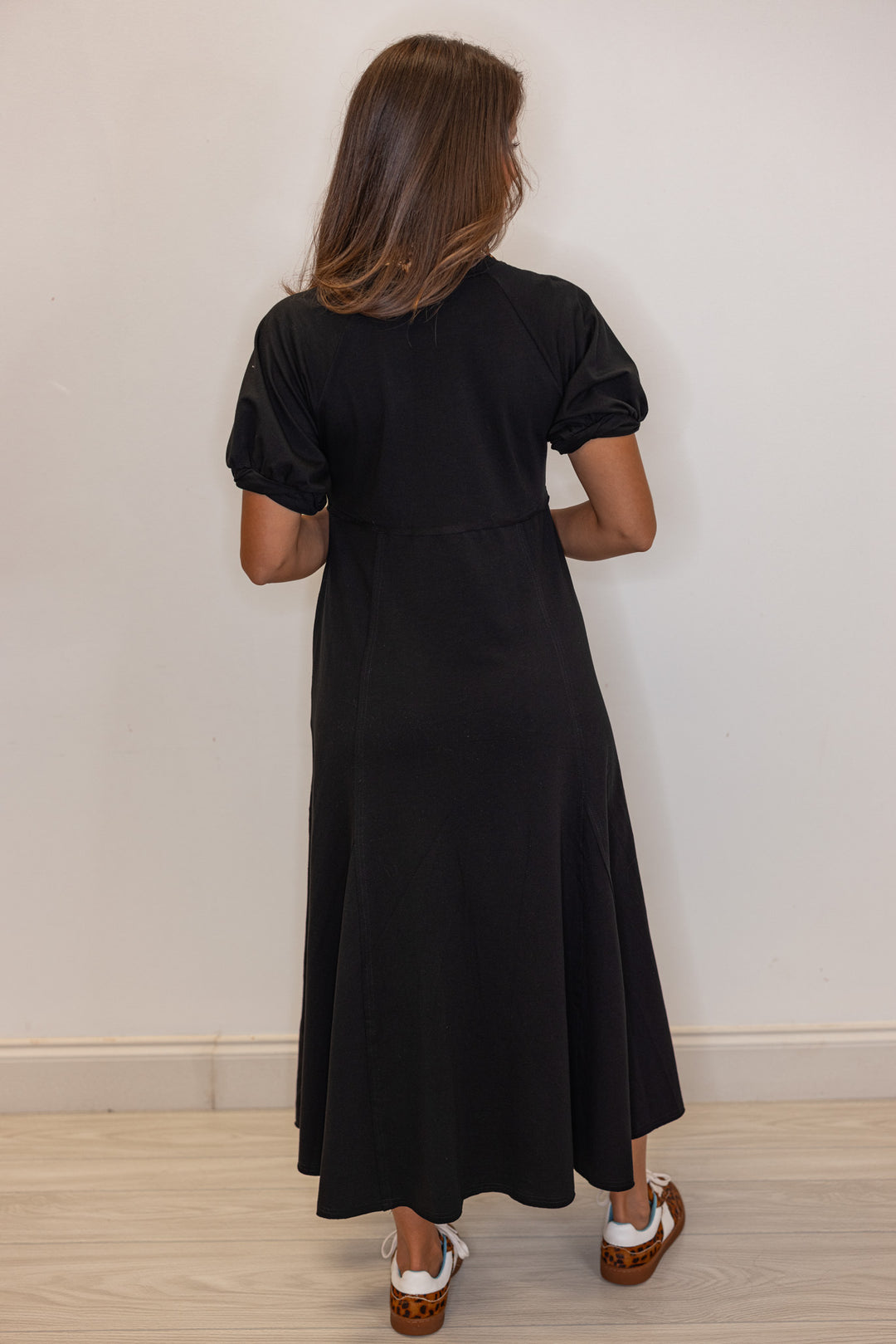 Black terry knit puff sleeve midi dress with raw seam details by Jodifl showing full back view