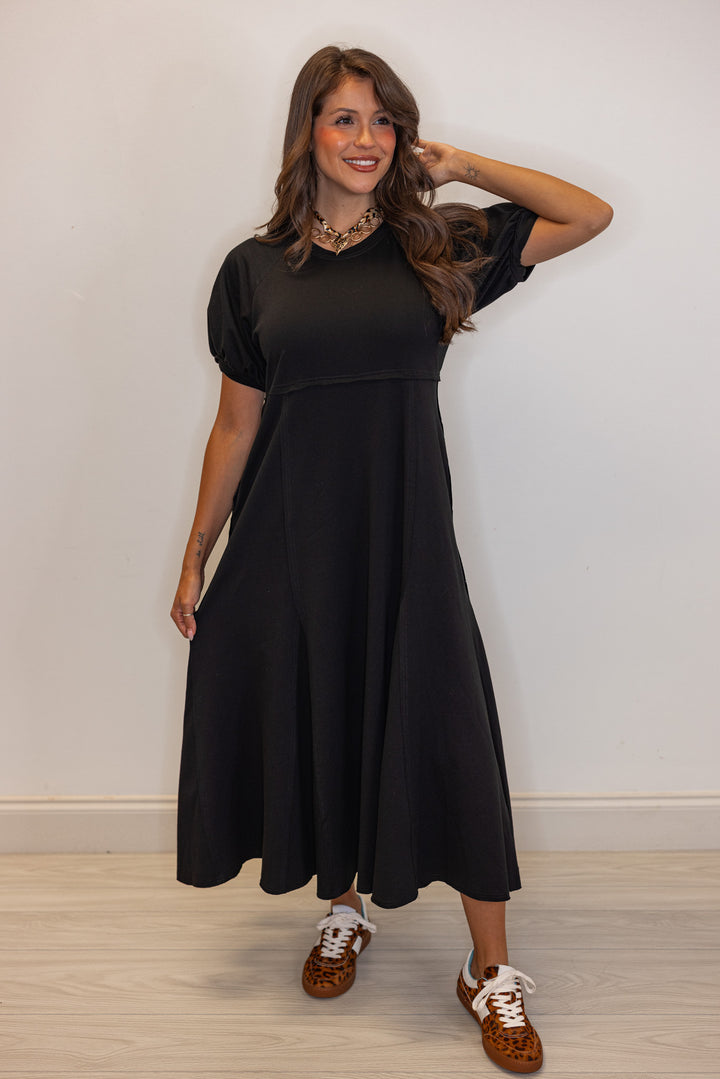 Black terry knit puff sleeve midi dress with raw seam details by Jodifl showing relaxed silouhette