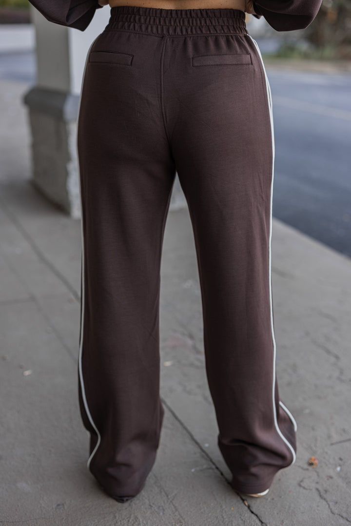 Women's chocolate brown scuba knit straight leg elastic waist pants by Rae Mode showing back view