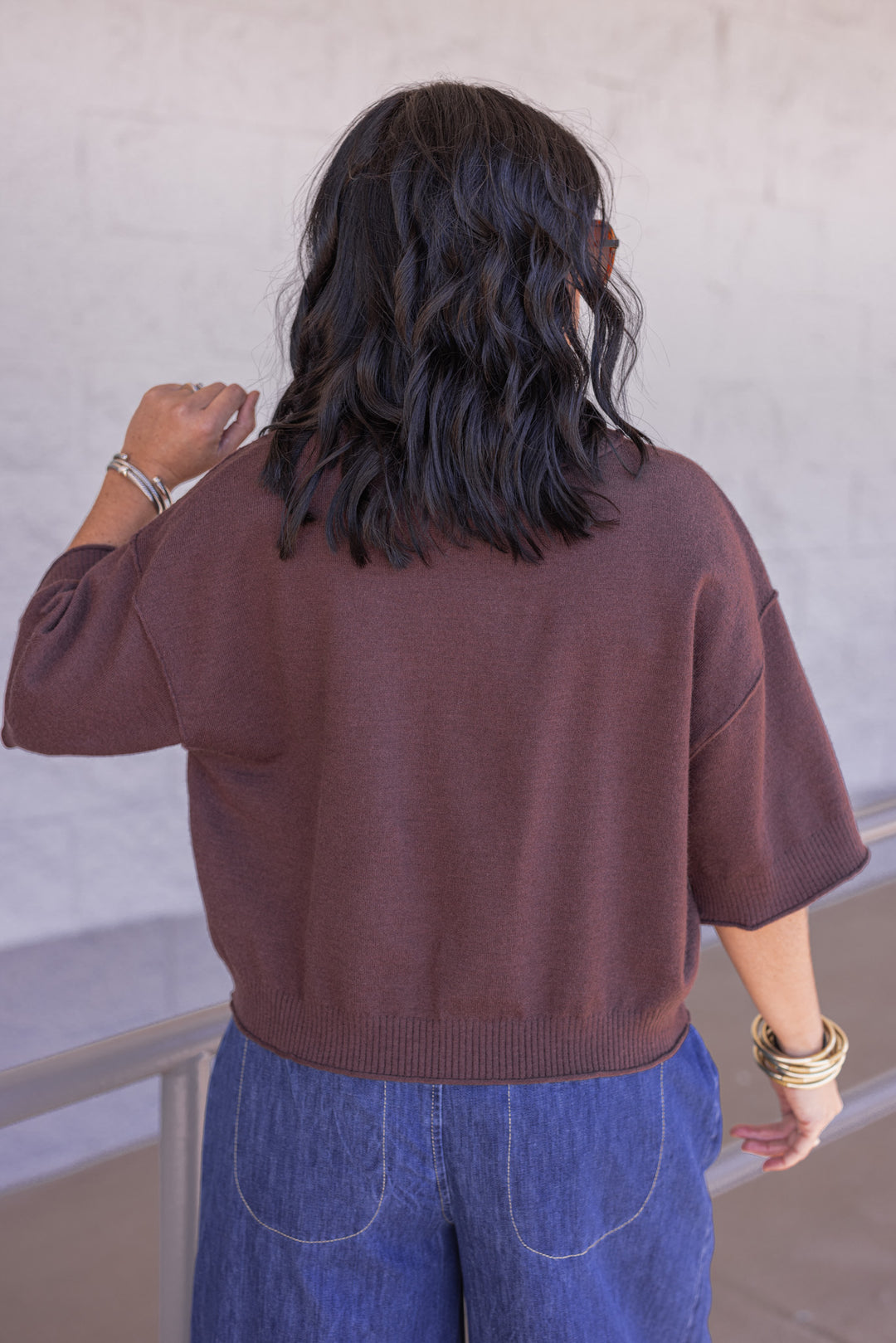 Women's brown knit top with reverse seam details by Entro showing back view