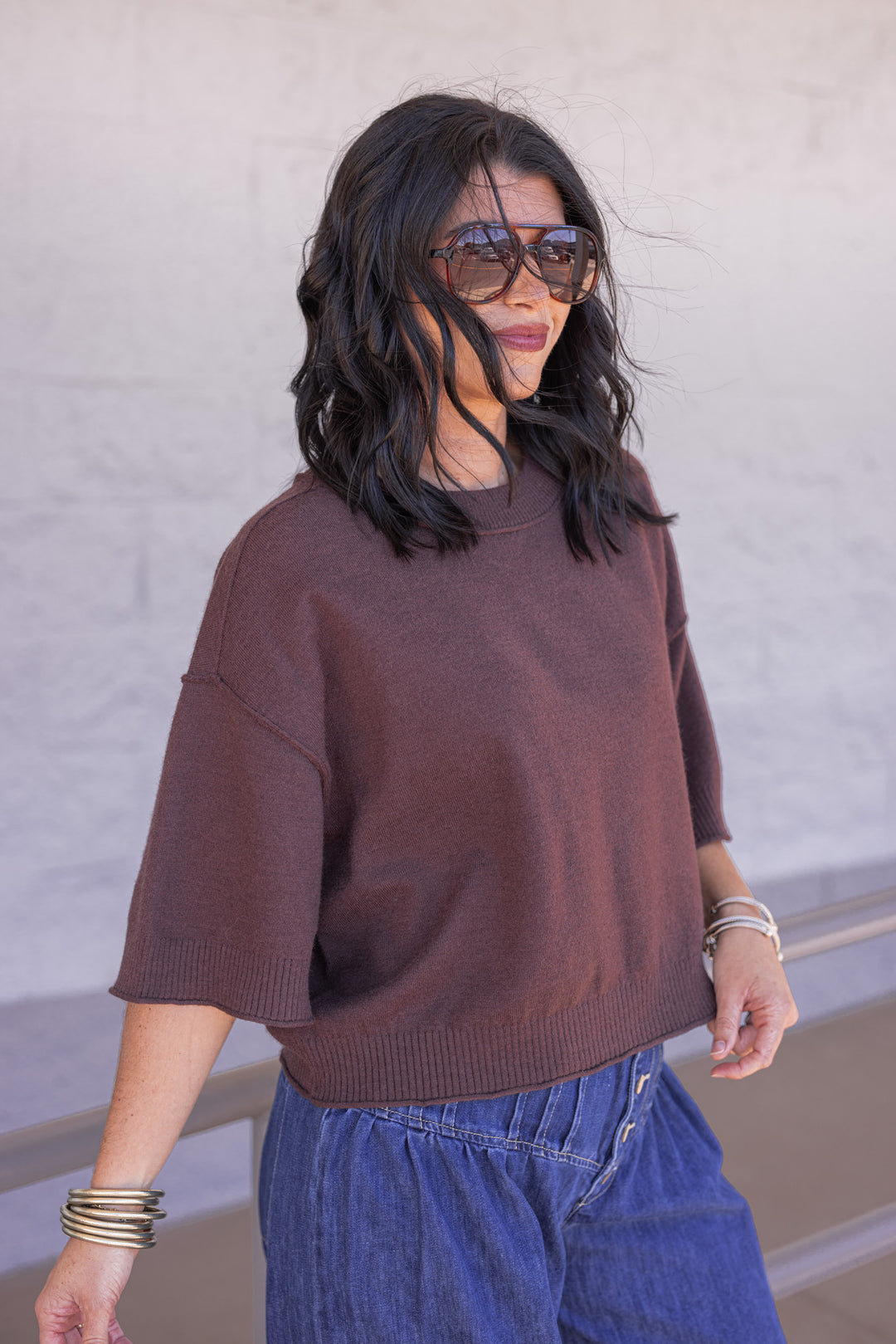 Women's brown knit top with reverse seam details by Entro showing slight side view