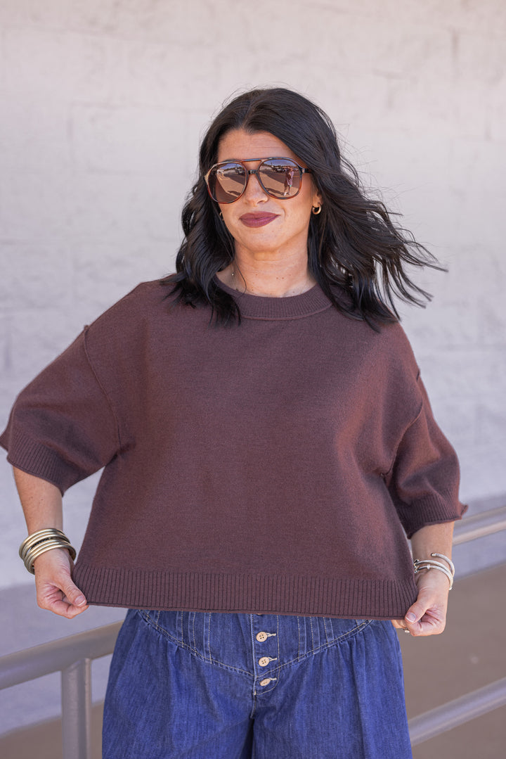 Women's brown knit top with reverse seam details by Entro showing semi-cropped length