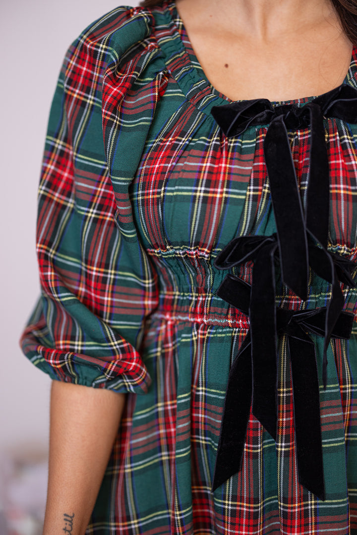 Women's green and red plaid midi dress  by Entro showing close look at velvet bow ties