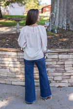 cream black trim bow sleeve top