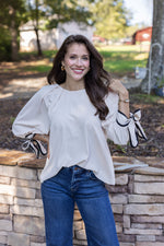 cream black trim bow sleeve top