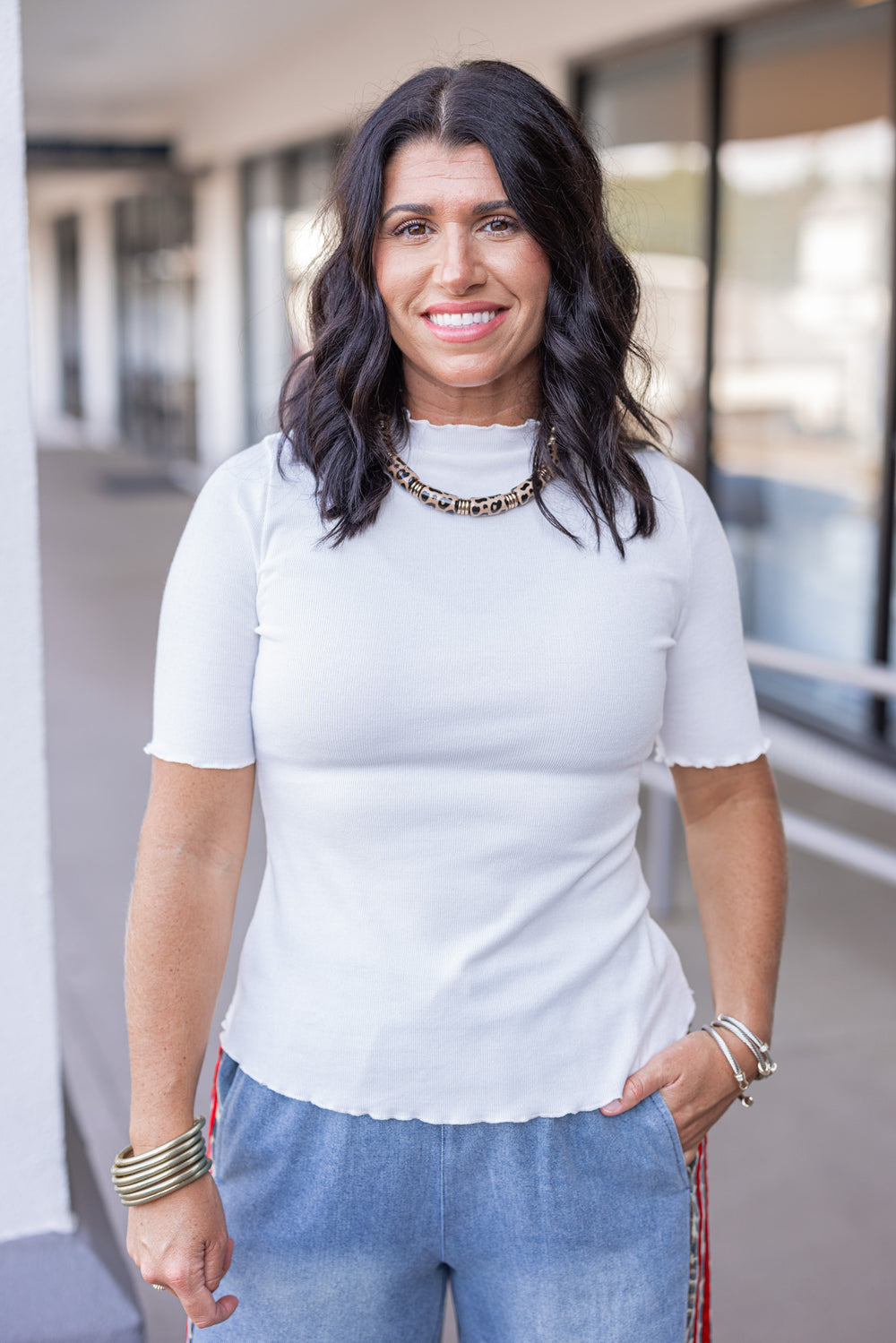 Women's ivory ribbed top with lettuce trim by Polygram showing up close front view