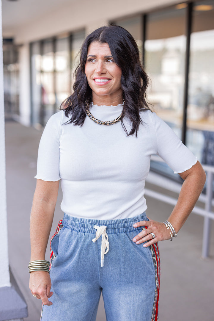 Women's ivory ribbed top with lettuce trim by Polygram
