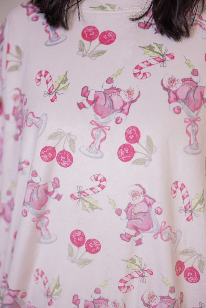 Women's white pajama lounge top with  bow tie details by Peach Love California showing up close look at holiday pink cherry santa print