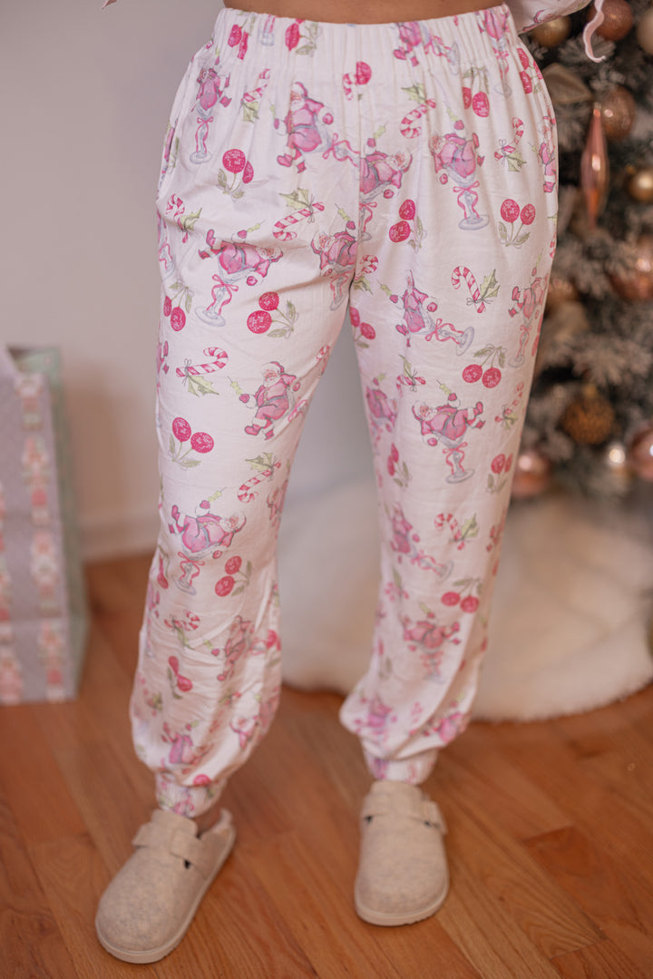 Women's white pajama lounge jogger pants with pink cherry santa print by Peach Love California showing up close front view