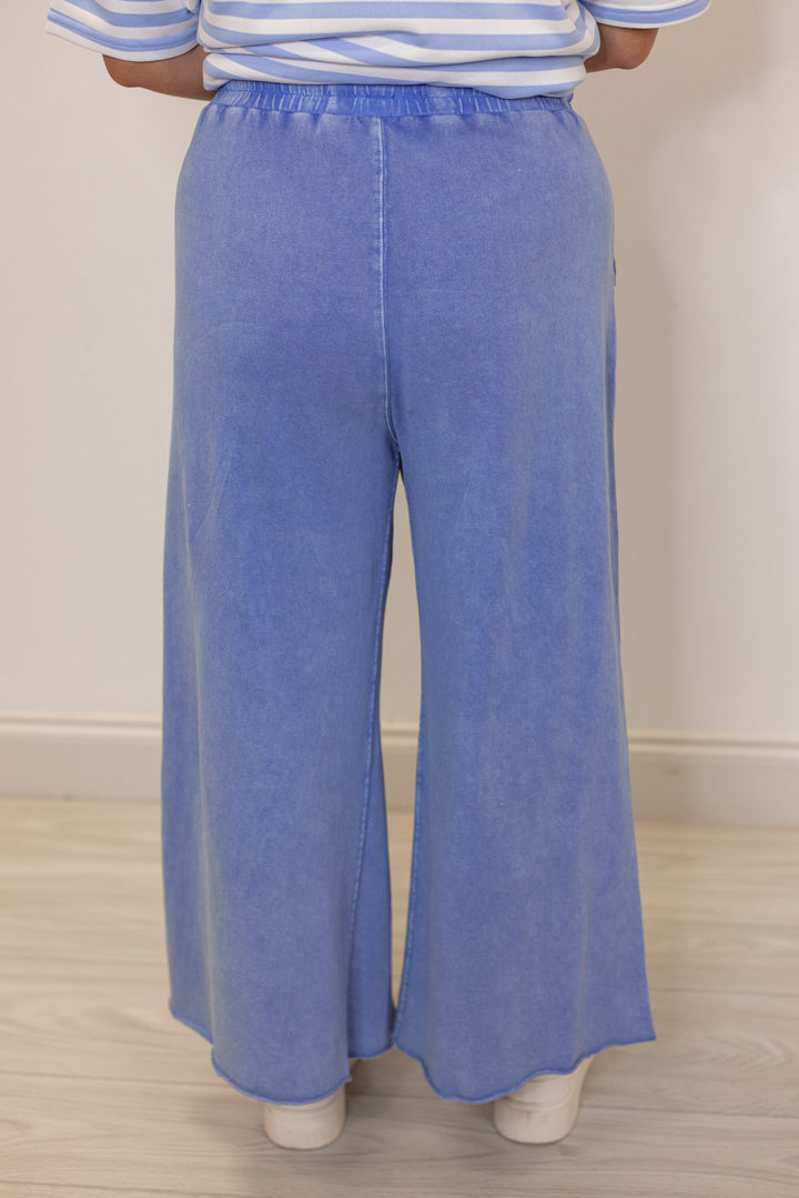 Women's mineral washed cornflower blue french terry knit wide leg cropped pants by Easel showing up close back view
