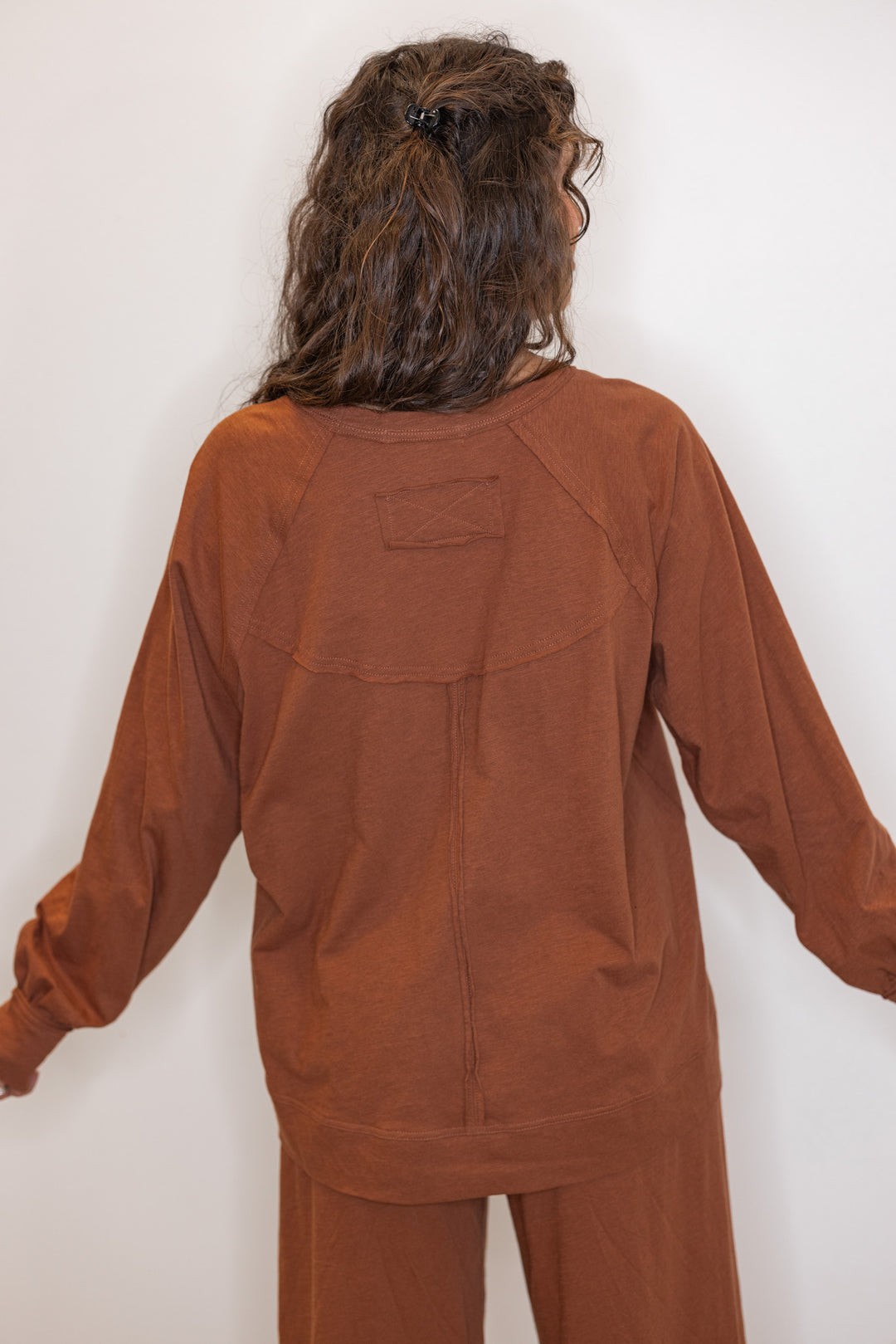 Back view of Women's chestnut brown athleisure long sleeve cotton tee