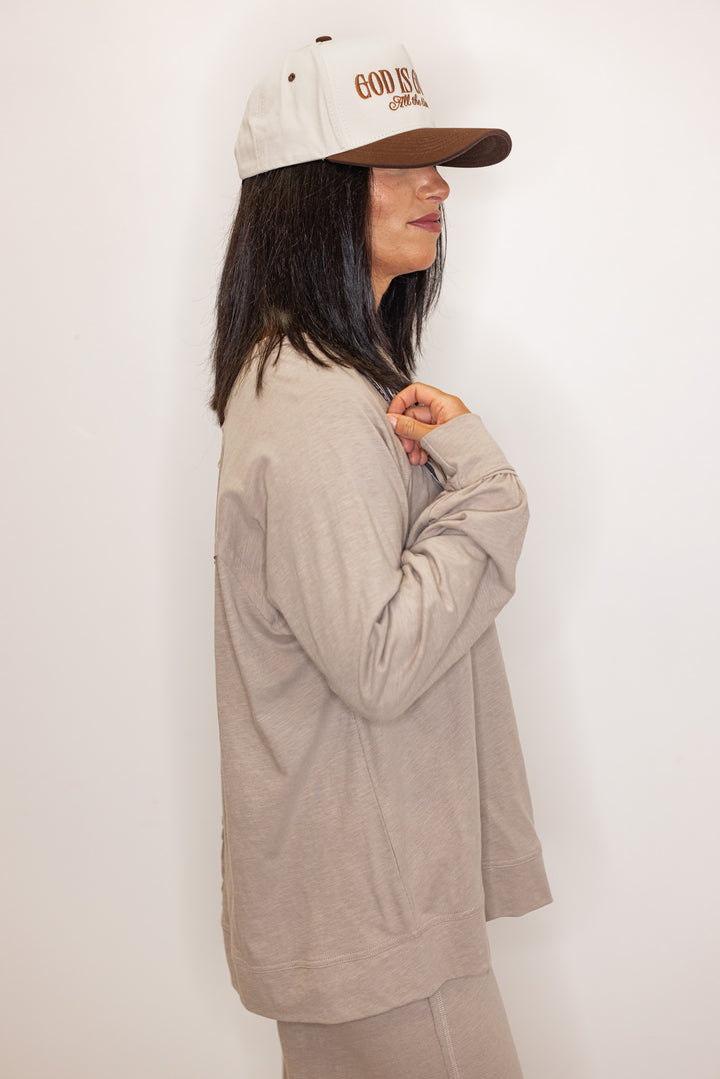 Side view of Women's beige long sleeve crew neck tee