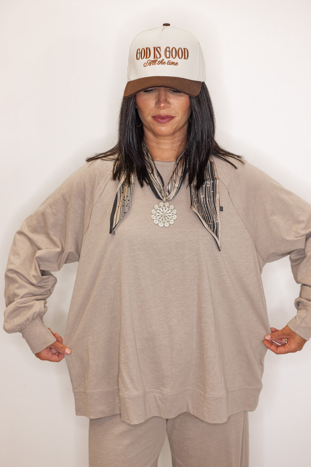 Women's beige long sleeve crew neck tee with beige and black tilly scarf