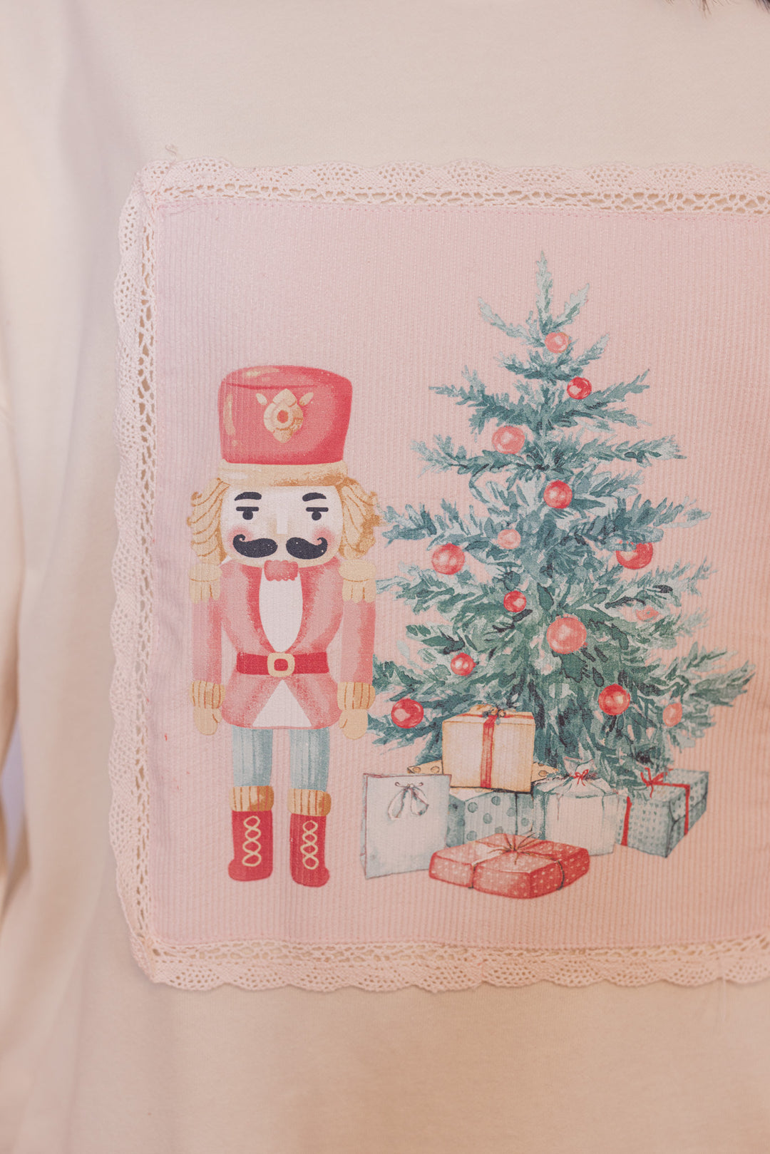 Women's cream corduroy patch sweatshirt with a nutcracker and Christmas tree by Peach Love California showing up close look at patch work detail