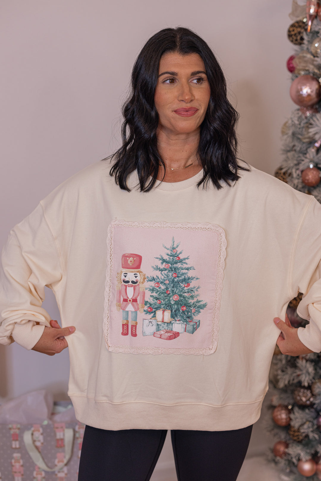 Women's cream corduroy patch sweatshirt with a nutcracker and Christmas tree by Peach Love California showing relaxed fit
