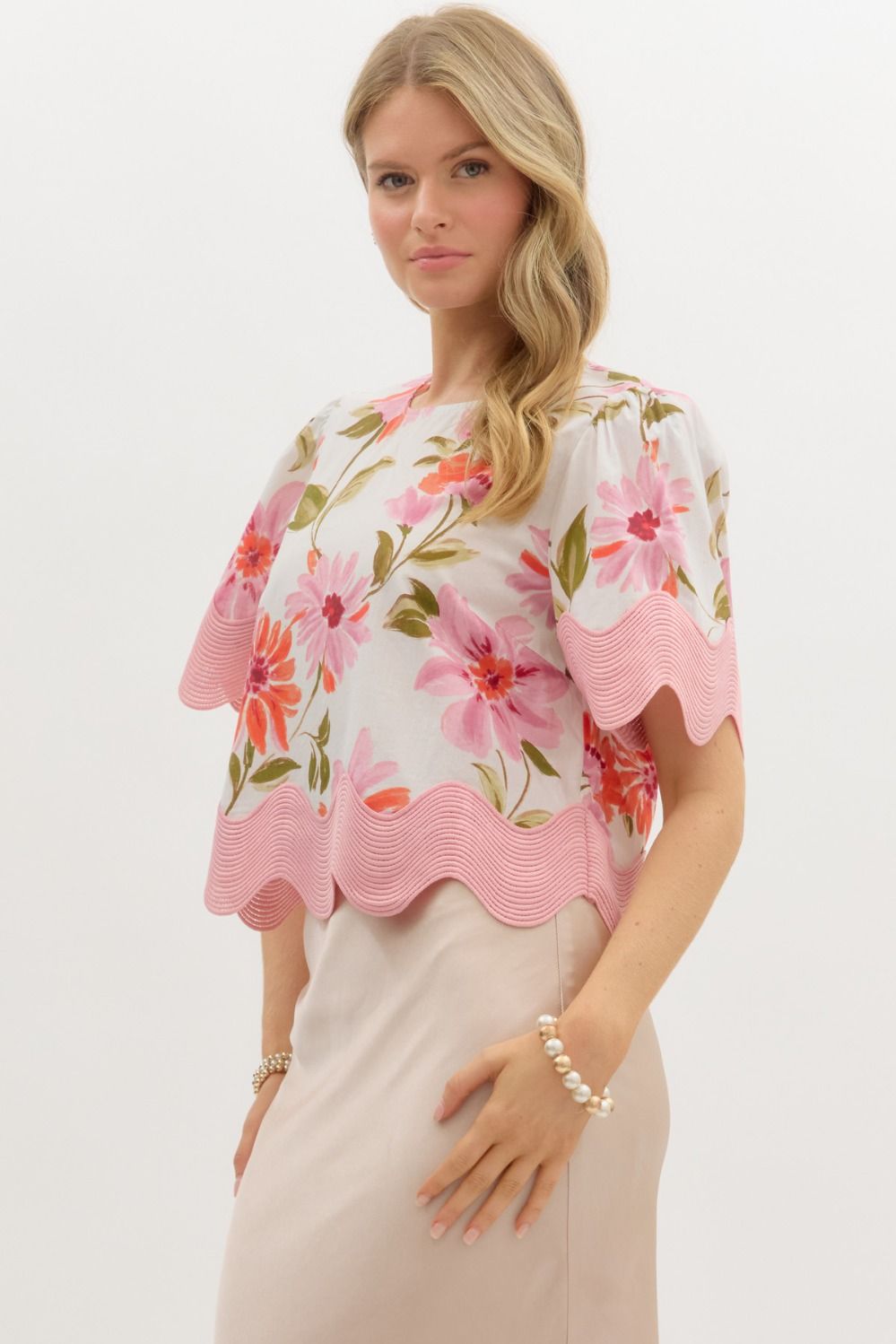 Women's cream and pink floral print top with scalloped trim by Entro showing slight side view